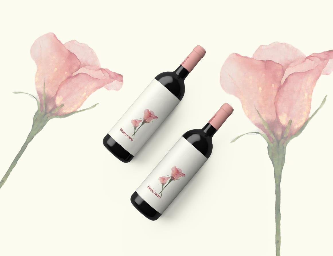 Two red wine bottles with pink lisianthus labels, beside painted lisianthus stems