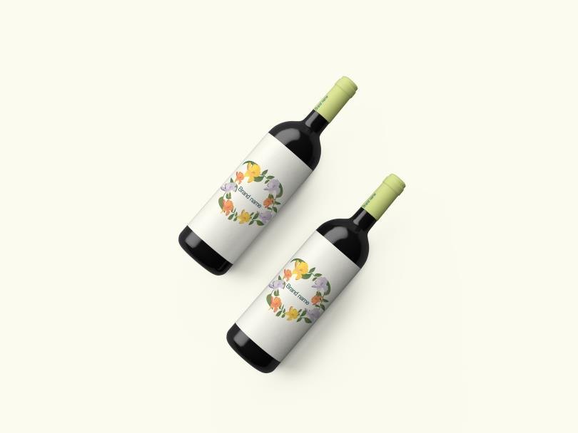 Two wine bottles with yellow botanical labels